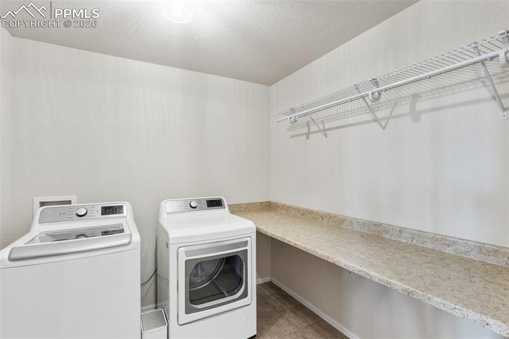 Image 16 of 32: Bathroom featuring a vanity with an integrated sink and light-toned counter