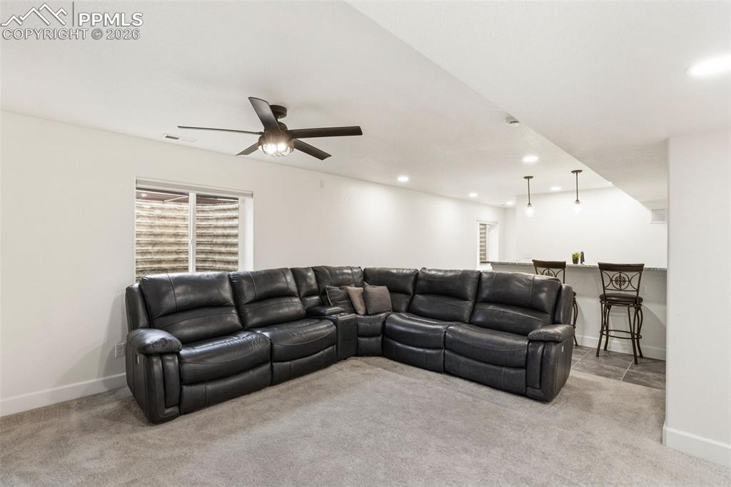 Image 18 of 32: Bedroom featuring a ceiling fan with integrated lighting, a window with ext