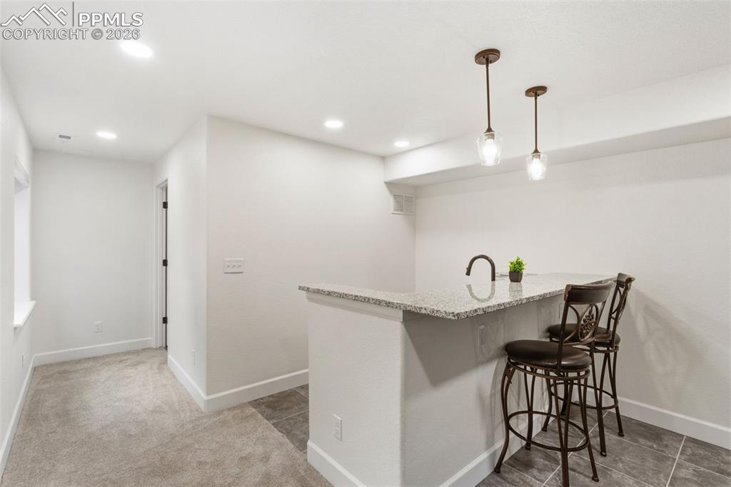 Image 19 of 32: Bright room with light-toned walls and plush carpeting