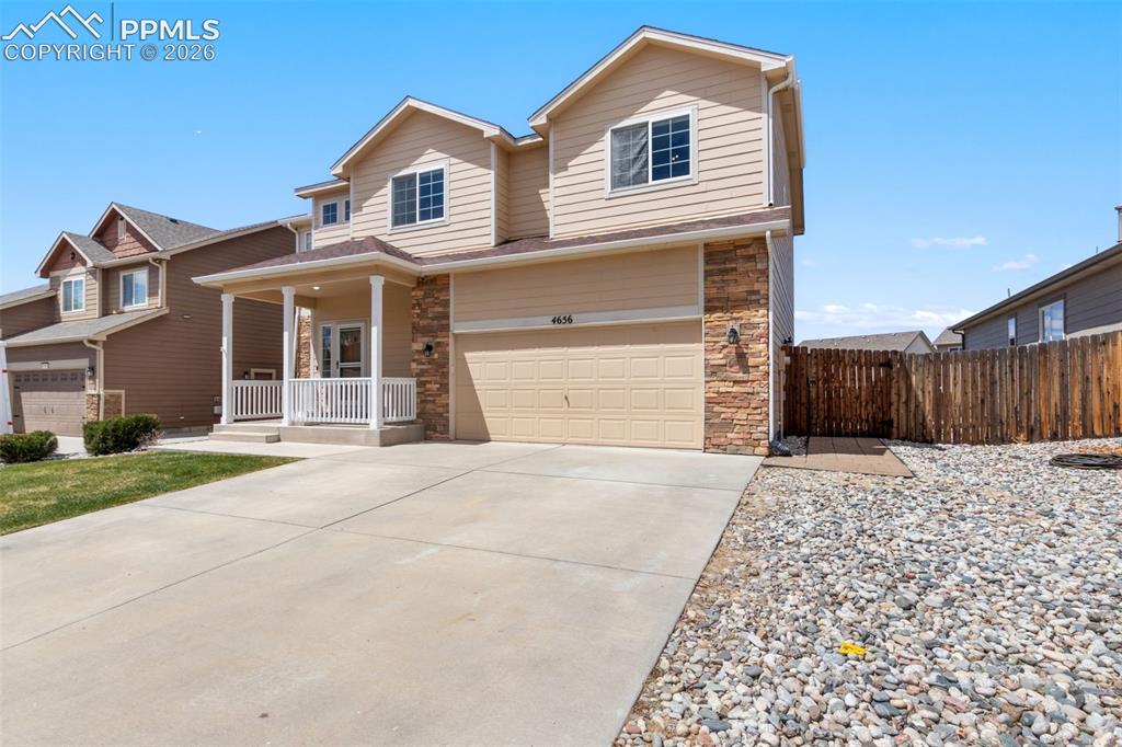 Image 28 of 32: Expansive backyard with a wood privacy fence and a gravel path