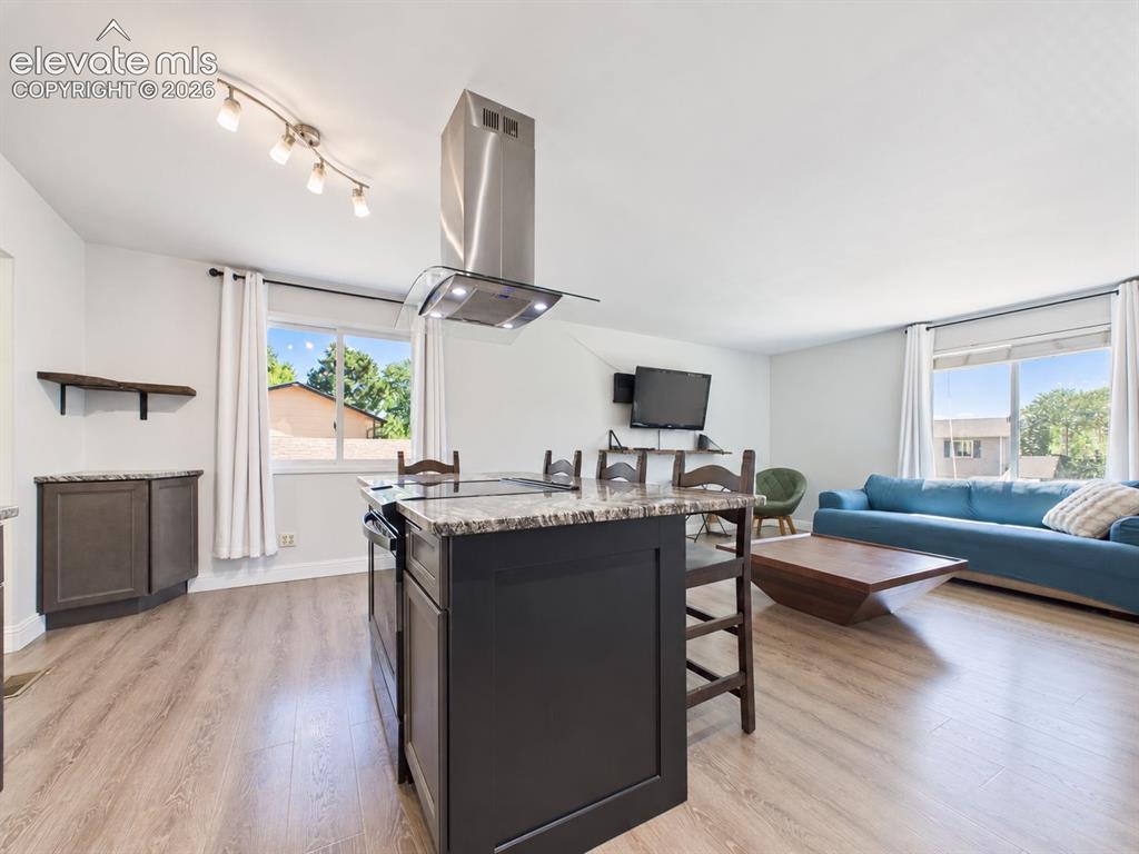 Image 11 of 50: Another expansive view showcases the island-centered kitchen opening direct