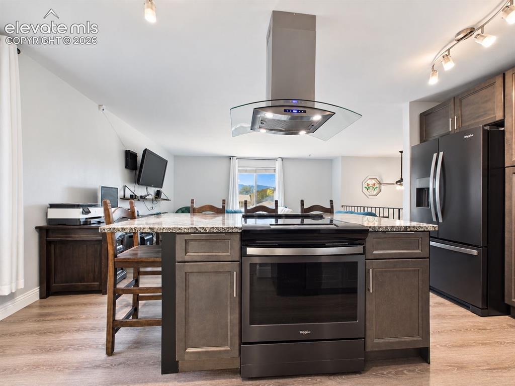 Image 16 of 50: The oversized island serves as the centerpiece of the kitchen, combining th