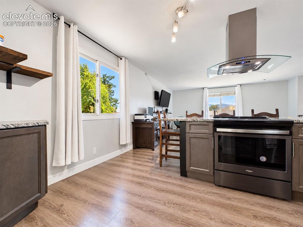 Image 18 of 50: Open kitchen view highlights the island cooking station with contemporary v