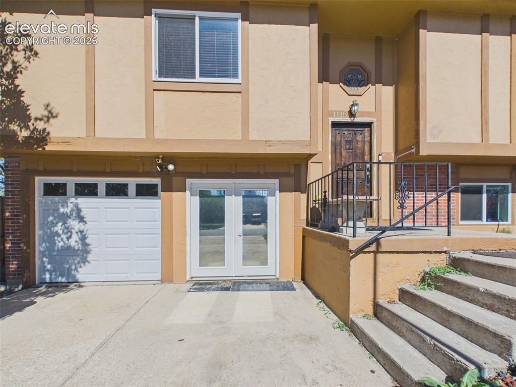 Image 2 of 50: Front view shows the one-car attached garage alongside the separately acces