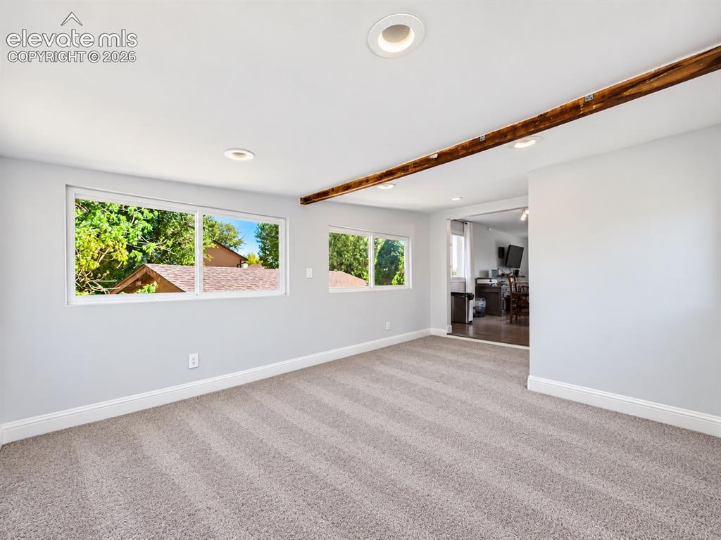Image 21 of 50: Additional sunroom view highlights the expansive carpeted floor area, multi