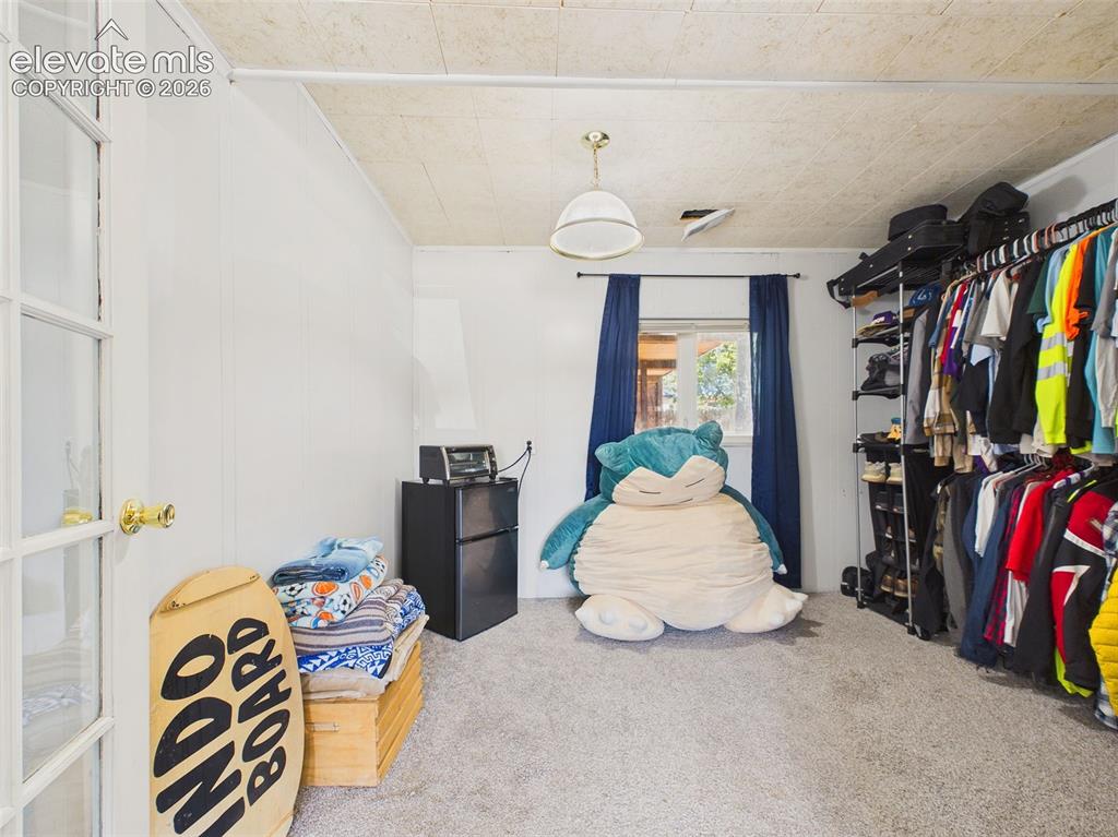 Image 32 of 50: Flexible adjoining space offers extensive open clothing storage, carpeting,