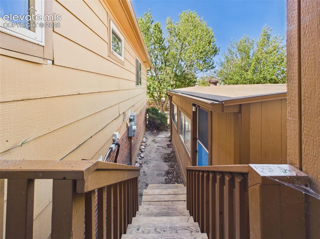 Image 37 of 50: Exterior stairs and a stone pathway provide access between levels and conne