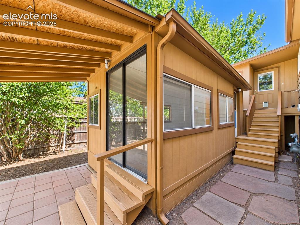 Image 38 of 50: Exterior view highlights the enclosed sunroom addition with multiple window