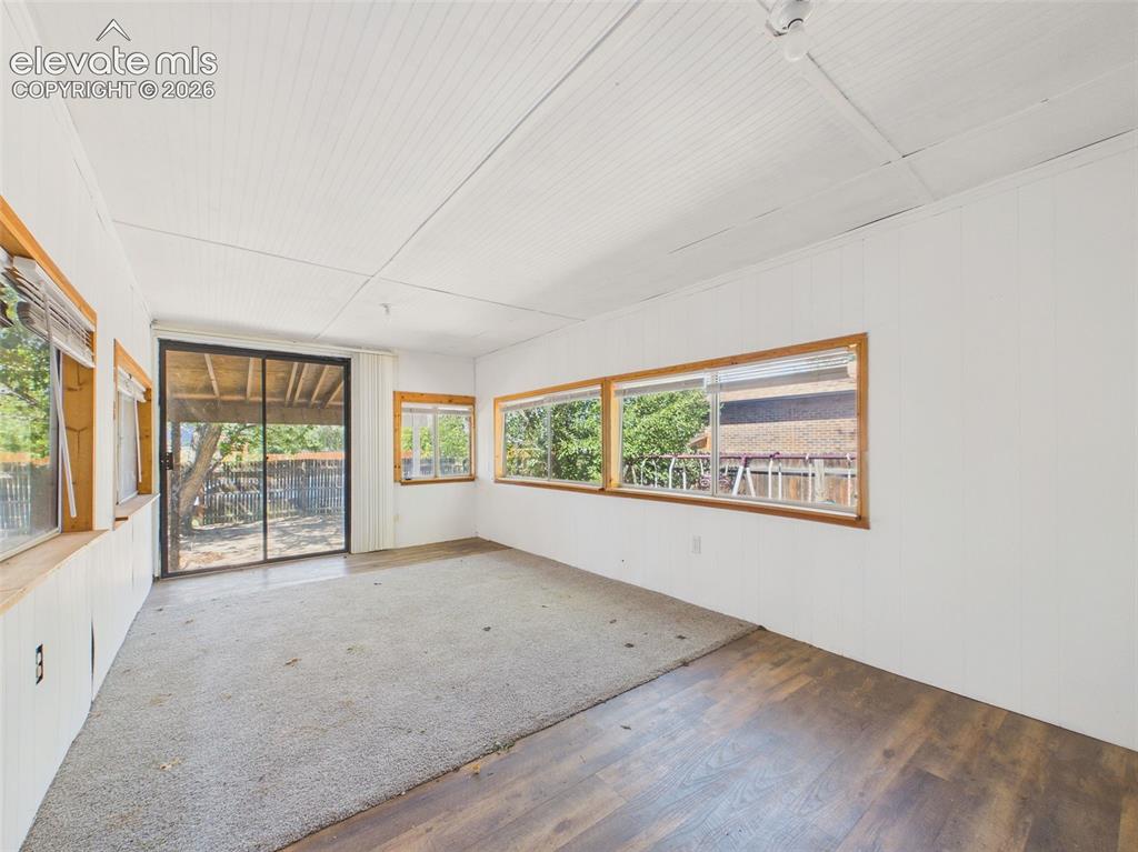 Image 40 of 50: Enclosed sunroom offers a generous footprint with windows on multiple sides