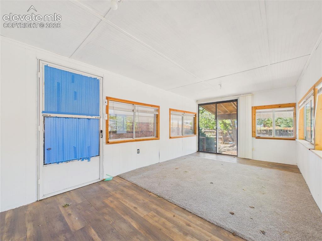 Image 41 of 50: Additional view of the enclosed sunroom highlights abundant windows, flexib
