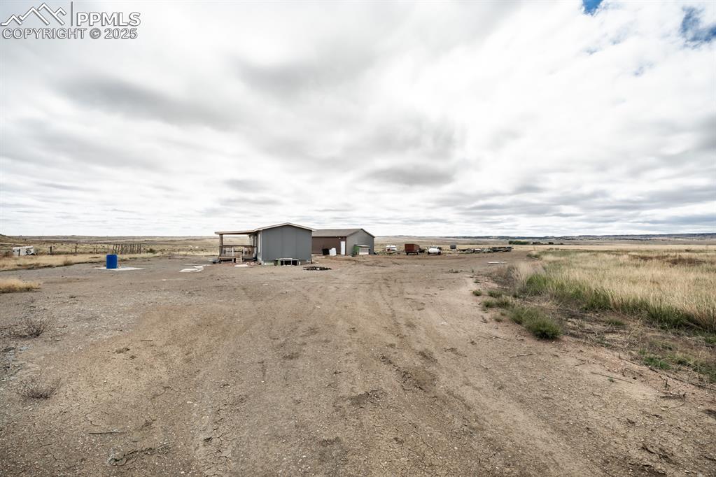 Caption: View of yard with a rural view and an outbuilding