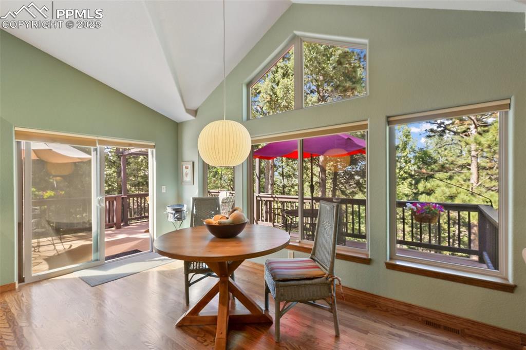 Image 16 of 43: Dining area featuring plenty of natural light, wood finished floors, and hi