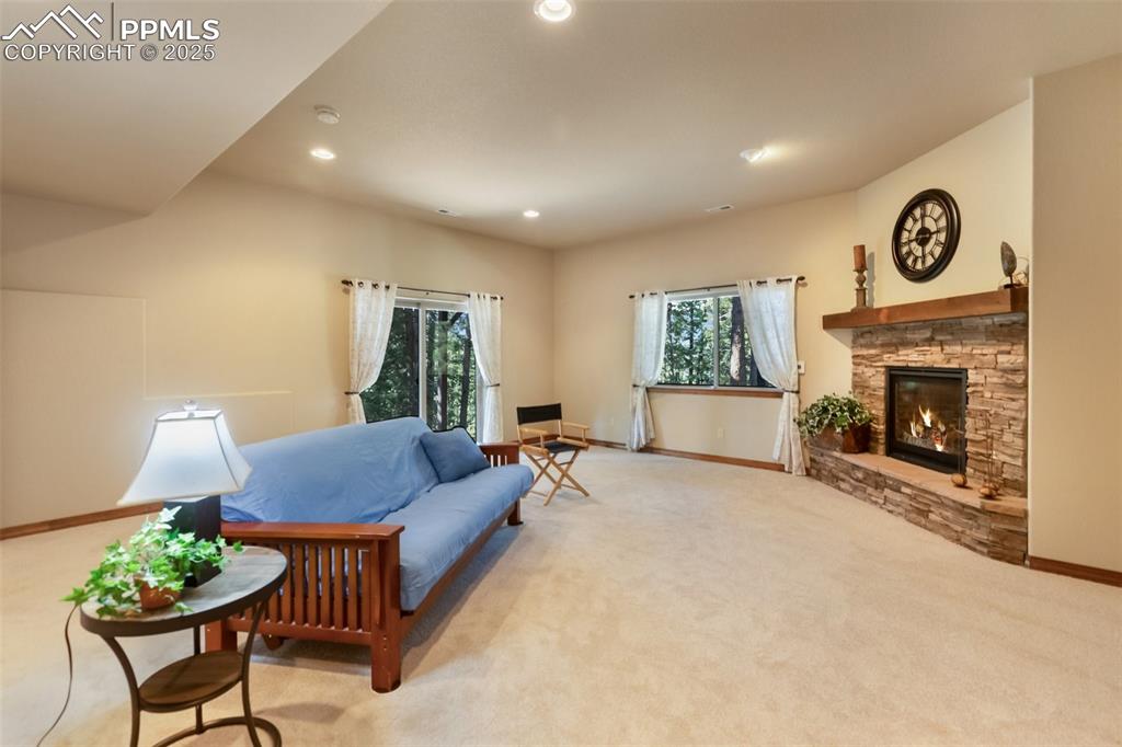 Image 23 of 43: Living room with light carpet, plenty of natural light, a fireplace, and re