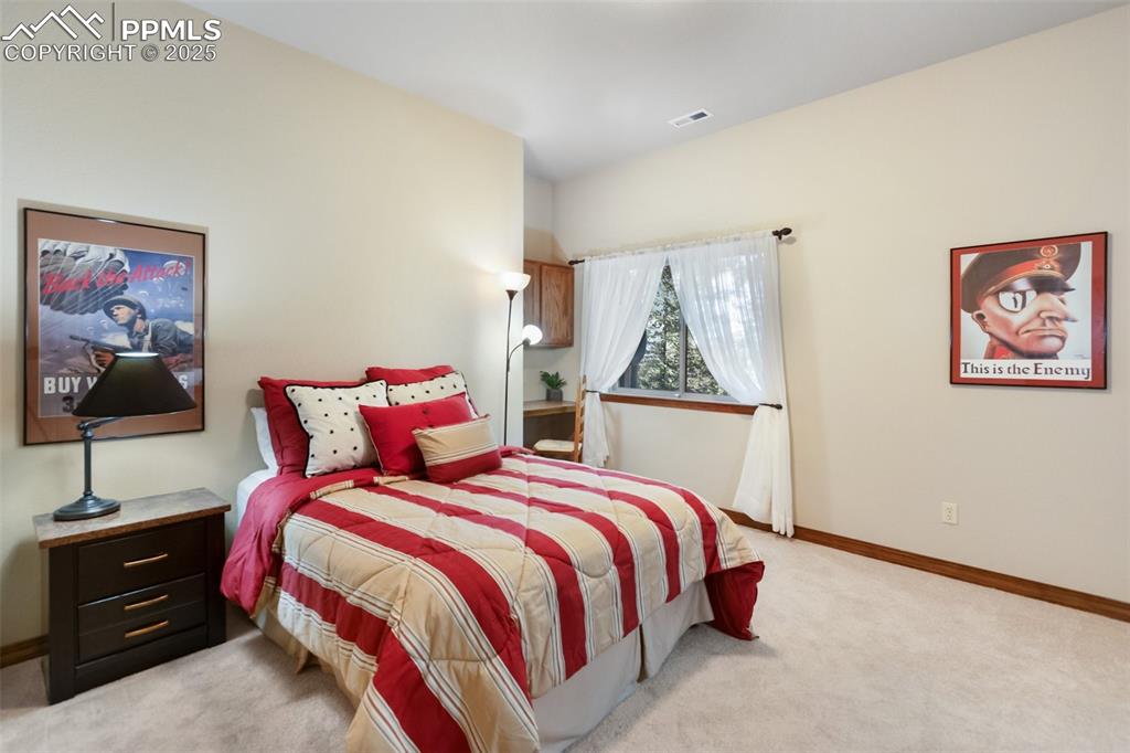 Image 35 of 43: Bedroom featuring light colored carpet and baseboards