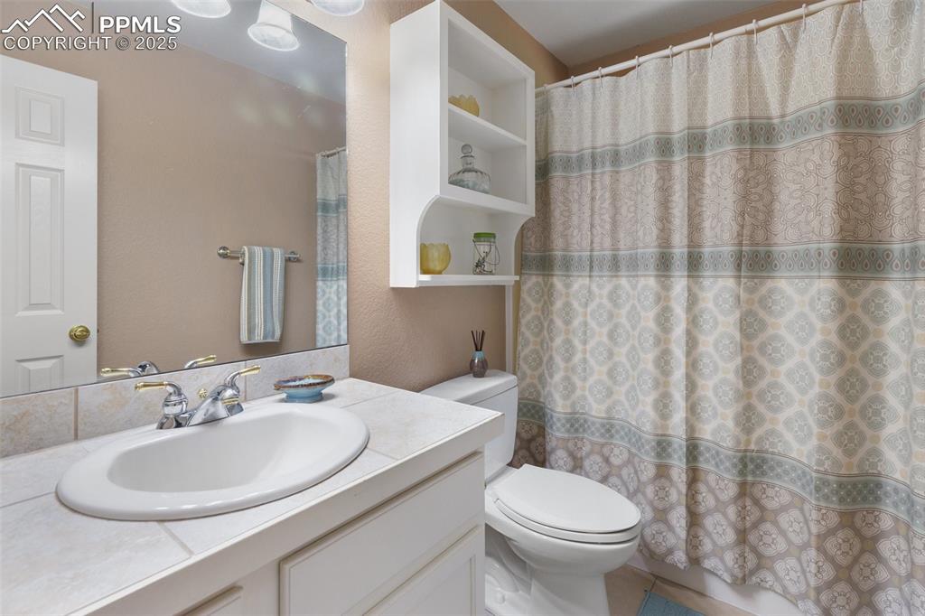 Image 37 of 43: Full bathroom featuring vanity and curtained shower