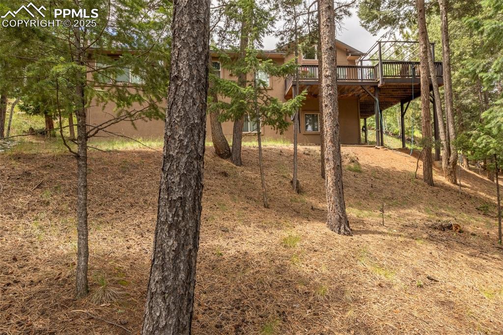 Image 42 of 43: View of yard and back elevation featuring a deck