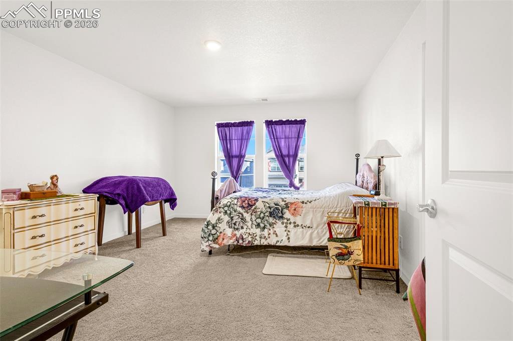Image 12 of 27: Bedroom with carpet flooring and baseboards