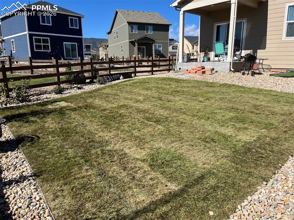 Image 26 of 27: View of yard with a patio and a residential view