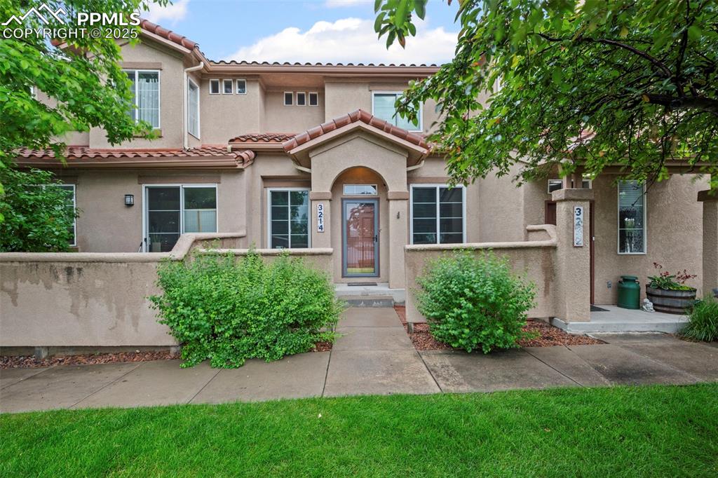 Caption: Mediterranean / spanish-style home with stucco siding and a tile roof