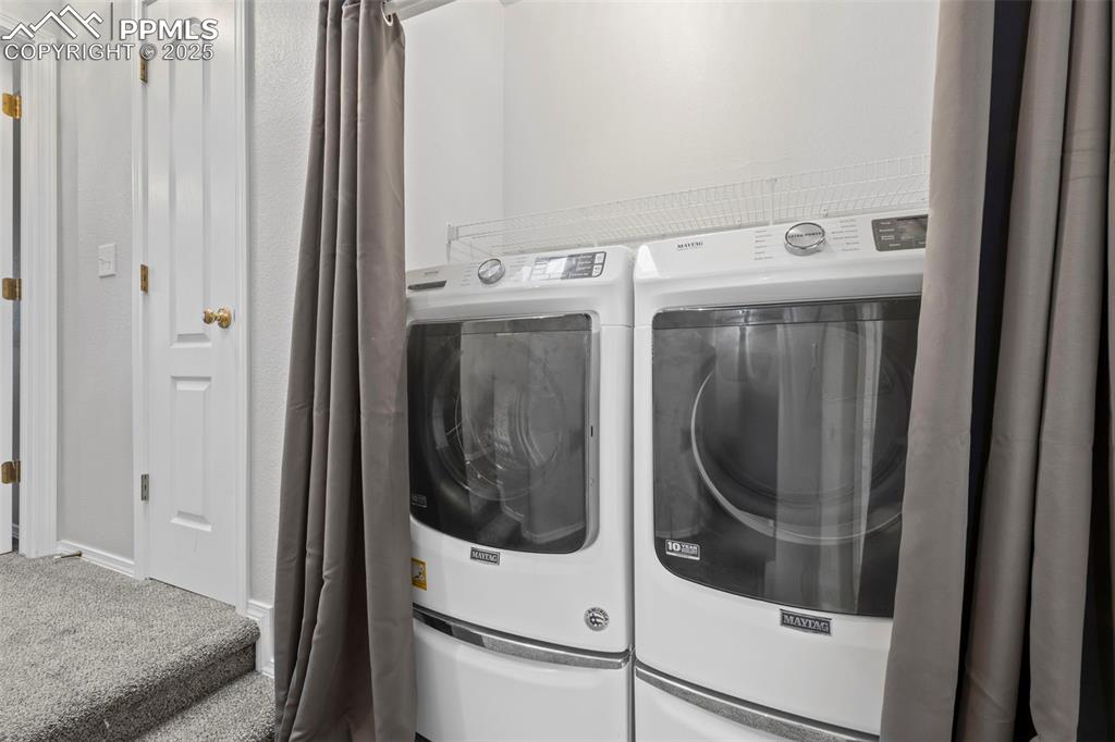 Image 14 of 33: Washroom featuring separate washer and dryer and carpet floors