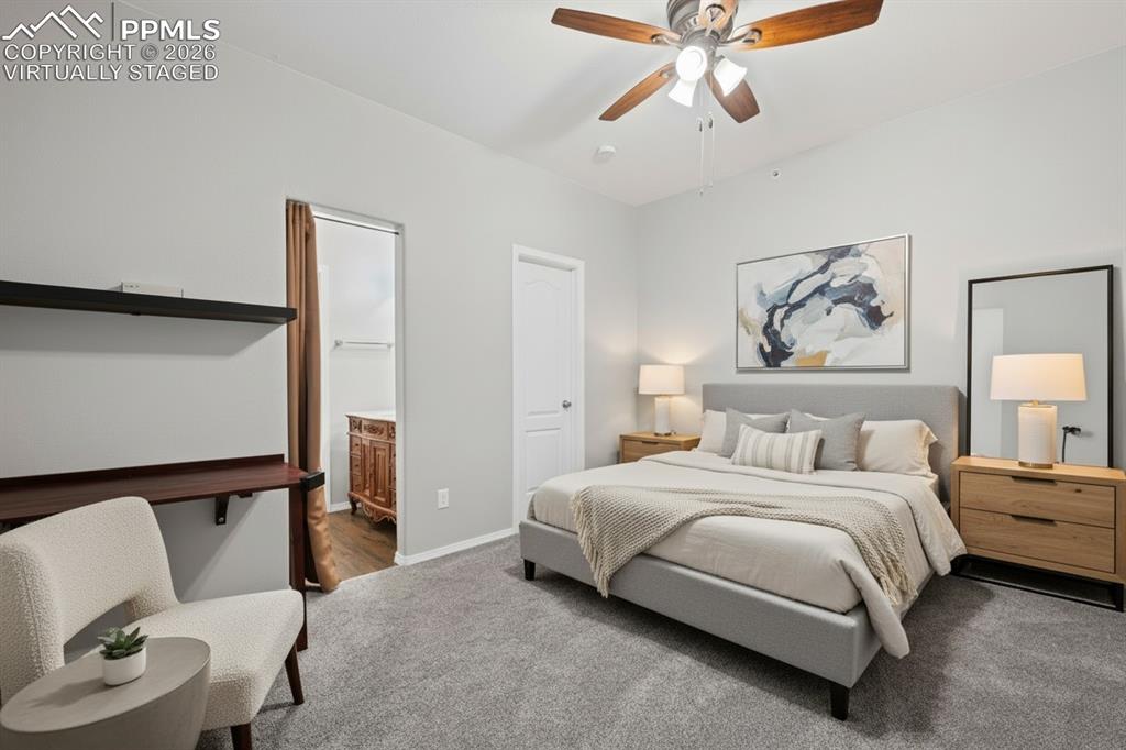 Image 15 of 33: Bedroom with en-suite bathroom. carpet, baseboards, custom window treatmen