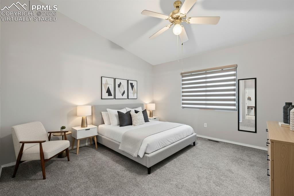 Image 17 of 33: Master bedroom with attached bathroom. Features custom window treatments, c