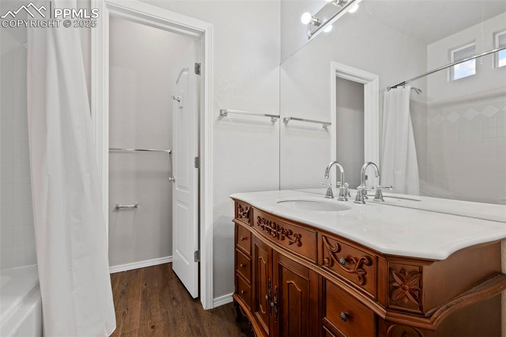 Image 18 of 23: Full bathroom featuring vanity, shower / bathtub combination with curtain,