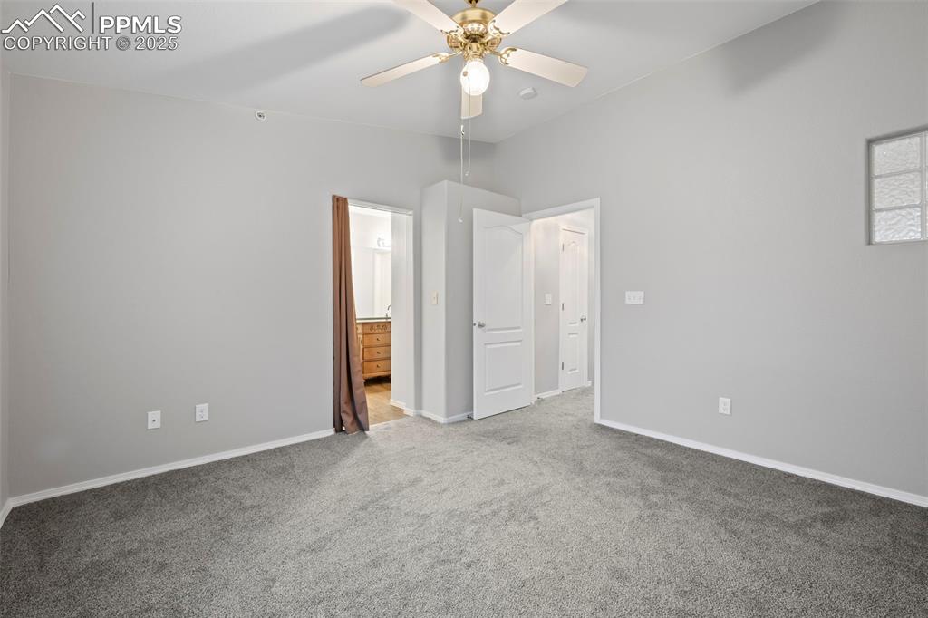 Image 21 of 23: Unfurnished bedroom featuring carpet, baseboards, connected bathroom, and c