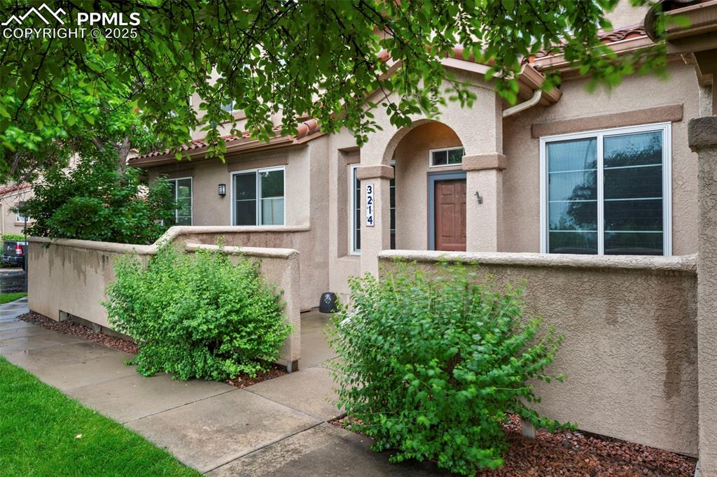 Image 3 of 33: View of front facade with stucco siding
