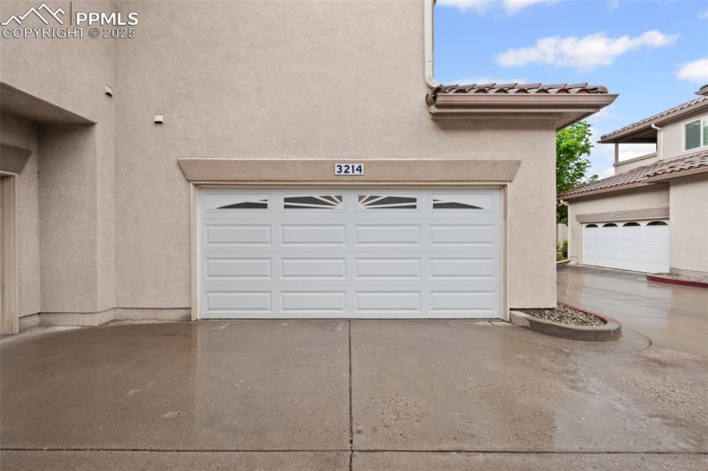 Image 4 of 23: Garage with driveway