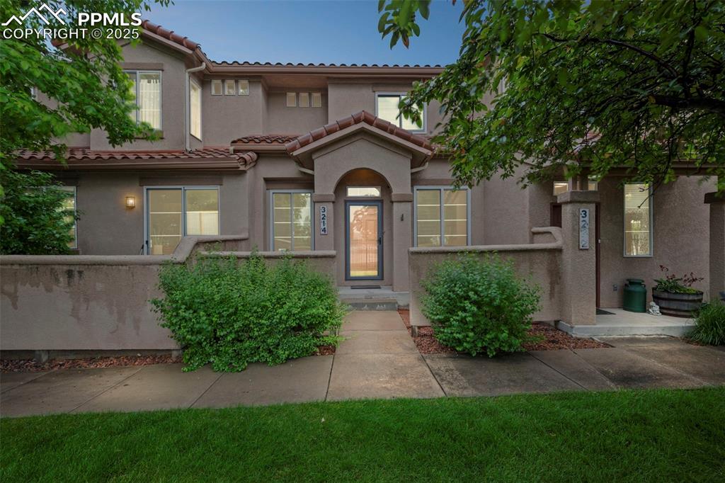 Image 7 of 33: Mediterranean / spanish-style home with stucco siding and a tile roof