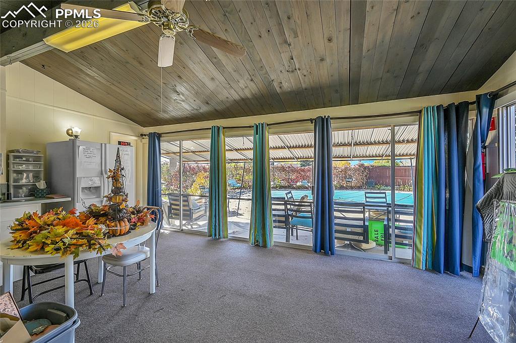 Image 30 of 42: Unfurnished sunroom featuring ceiling fan, wooden ceiling, and lofted ceili