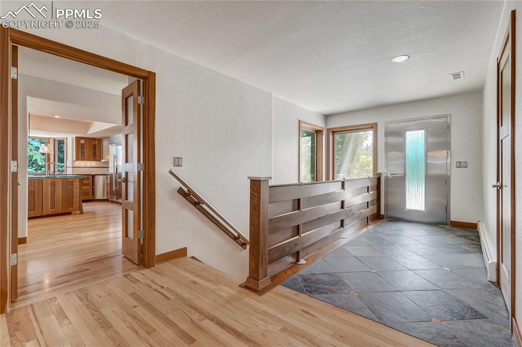 Image 3 of 50: Foyer entrance featuring light wood-style floors, a baseboard heating unit,