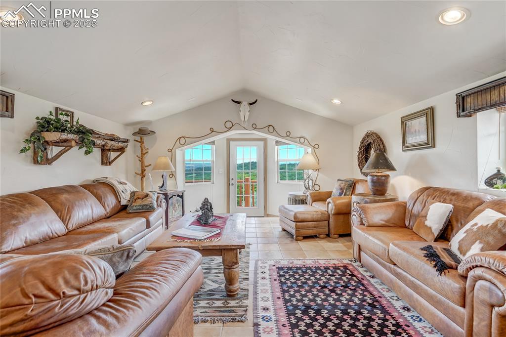 Image 34 of 50: Living area featuring recessed lighting, light tile patterned flooring, and