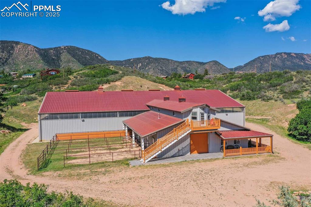Image 39 of 50: Aerial view of property and surrounding area featuring a mountain backdrop