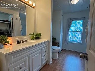 Image 24 of 34: Bathroom vanity featuring a white countertop, undermount sink, and wood-fin
