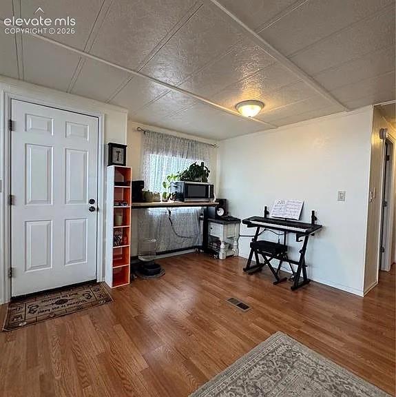 Image 7 of 34: View of front door and open space under the window
