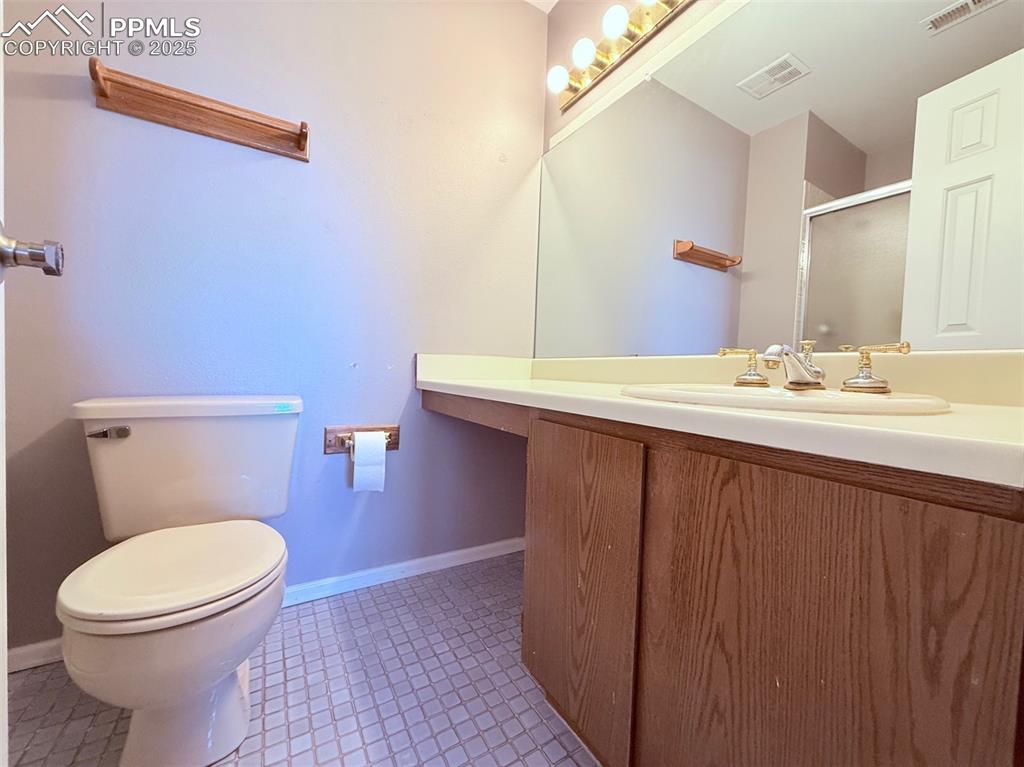 Image 20 of 35: Bathroom featuring vanity and a stall shower