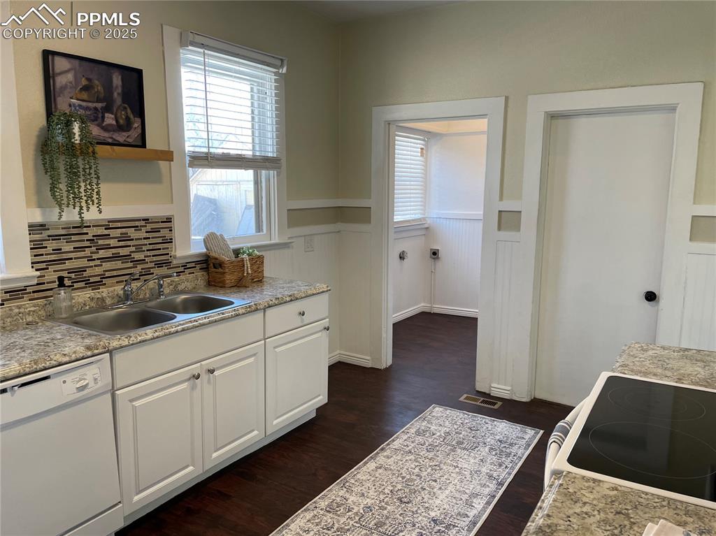 Image 7 of 30: Laundry room on left, basement door on right