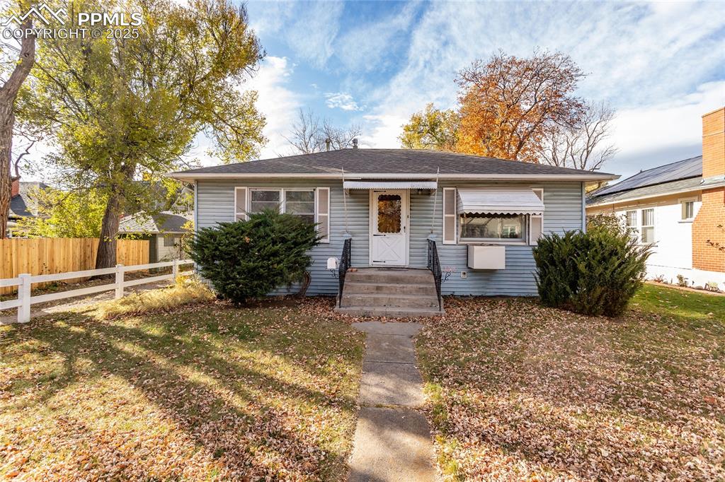 Caption: Bungalow-style house featuring a shingled roof