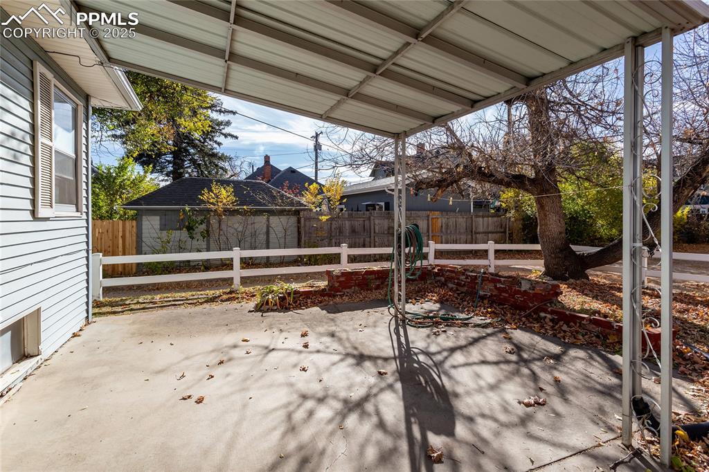 Image 18 of 24: Fenced backyard featuring a patio