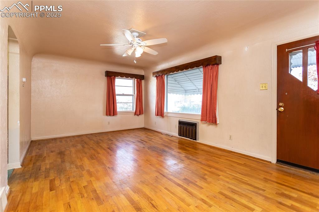 Image 4 of 24: Entryway with heating unit, light wood-style floors, and ceiling fan
