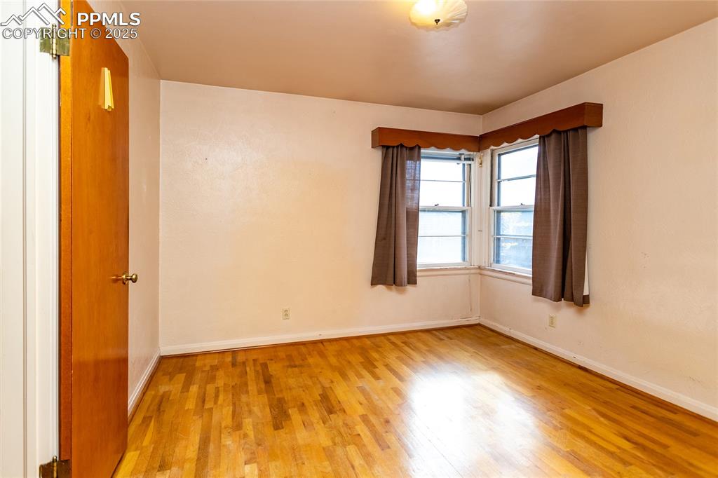 Image 6 of 24: Unfurnished room featuring light wood-style floors and baseboards