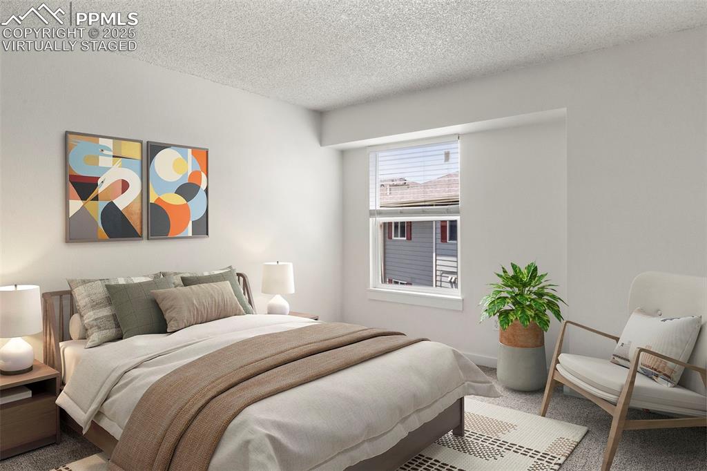 Image 14 of 24: Virtually staged - Carpeted bedroom with a textured ceiling and baseboards