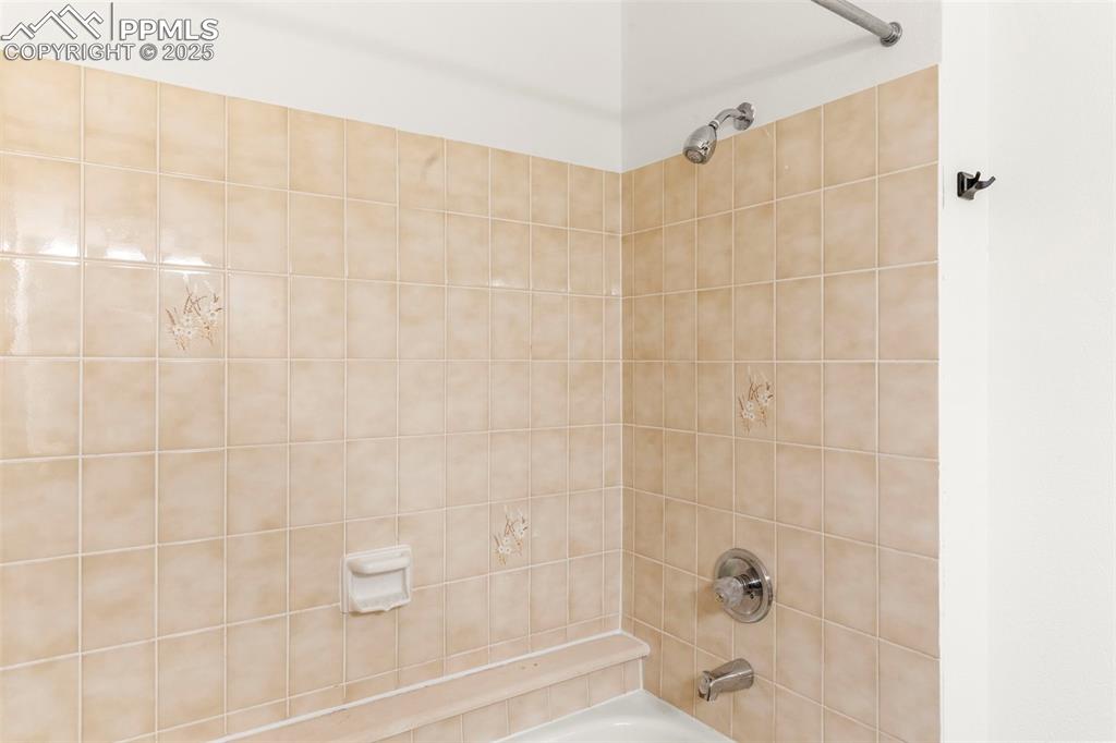 Image 18 of 24: Bathroom featuring shower / bathtub combination