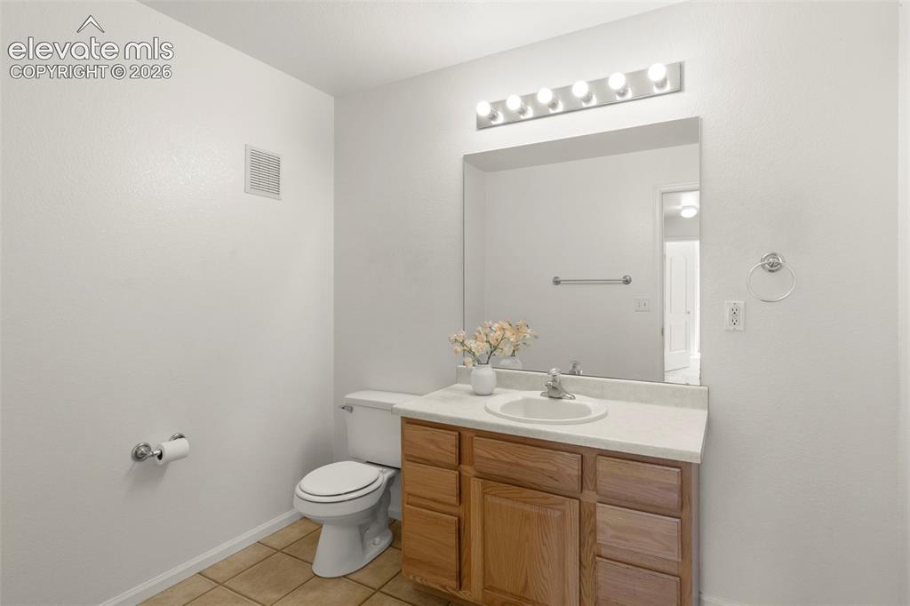 Image 10 of 22: Bathroom featuring a light-toned vanity with an integrated sink, a large wa