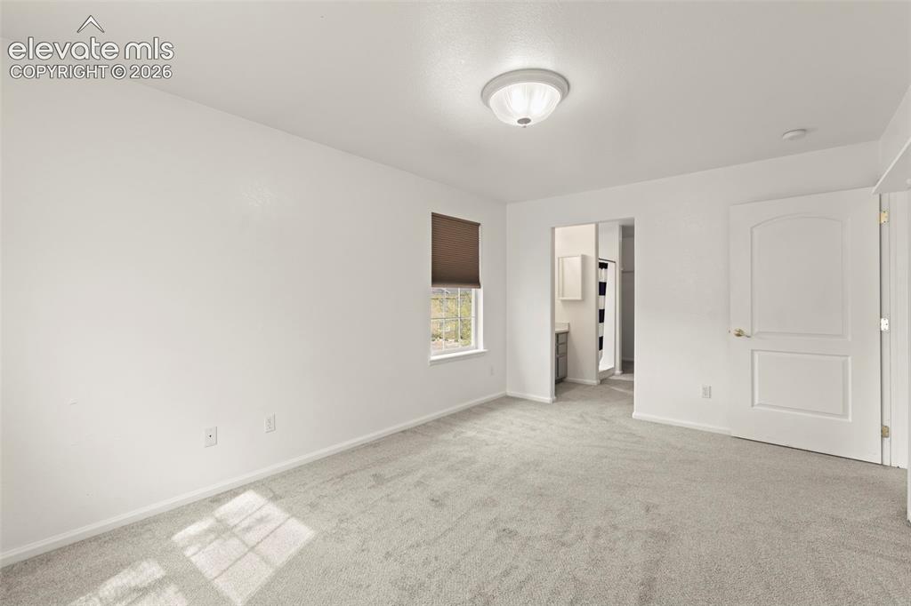 Image 15 of 22: Spacious room featuring light gray carpeting, neutral wall finishes, a wind