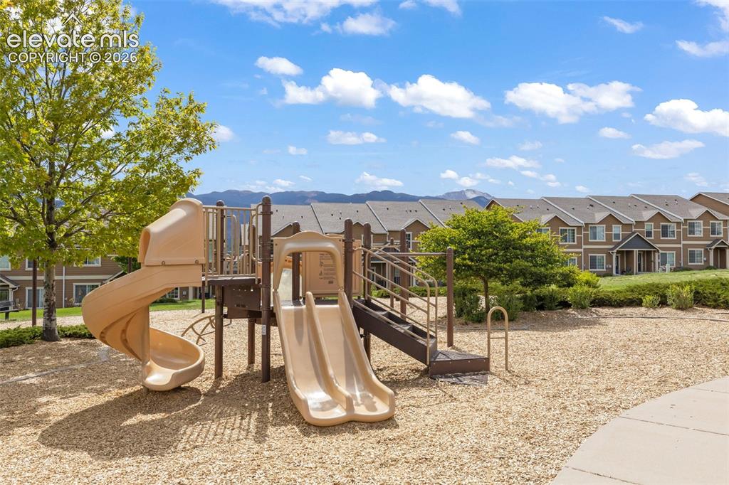 Image 21 of 22: Community playground featuring multiple slides, climbing structures
