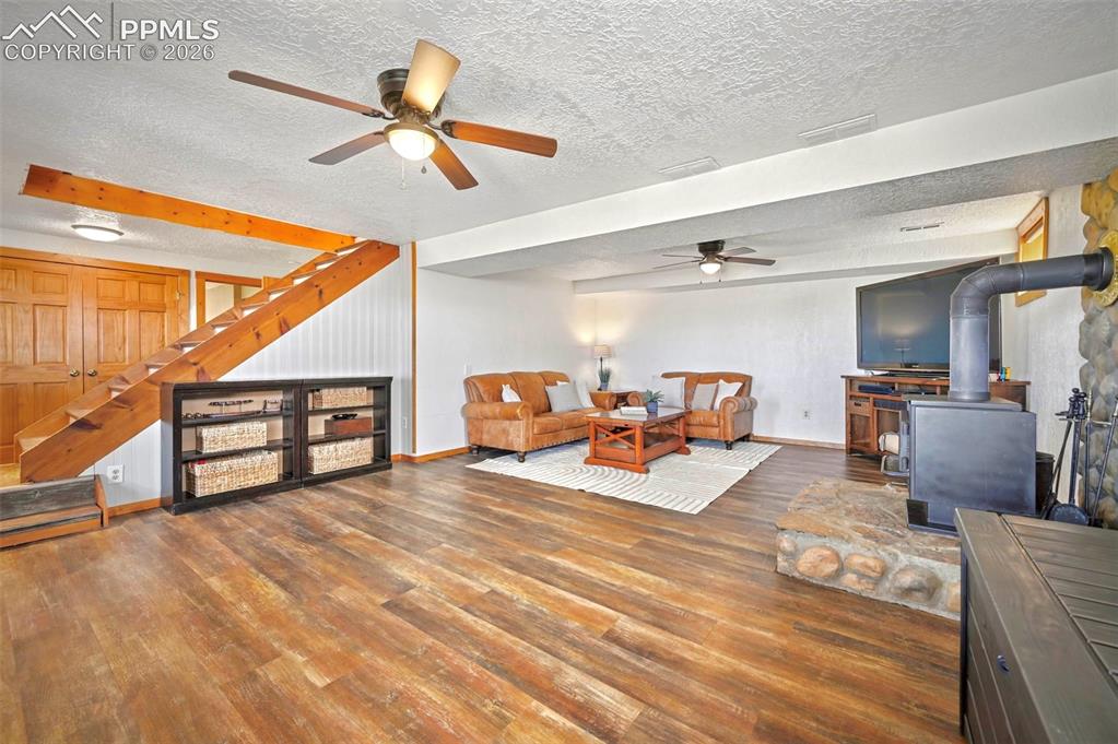 Image 20 of 34: Lower Level Living Room with wood burning stove