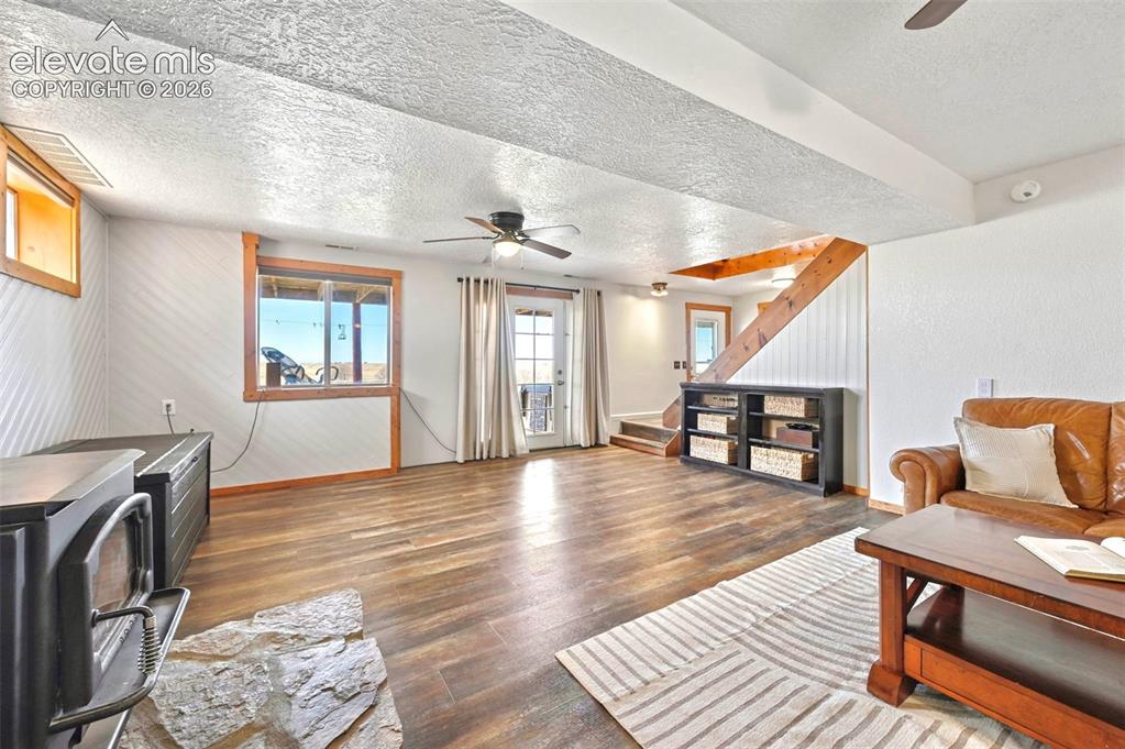 Image 21 of 34: Lower Level Living Room with wood burning stove